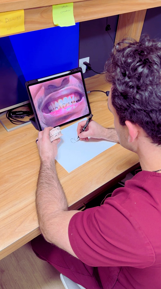 A dentist using a digital device to examine a patient s teeth.